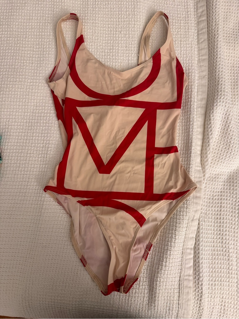 Beige One-Piece Toteme Swimsuit with Bold Red Graphic